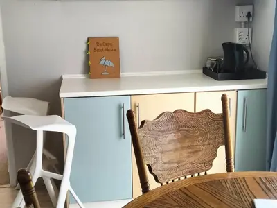 a kitchen with a chair next to a counter at Da Capo in Bettyʼs Bay