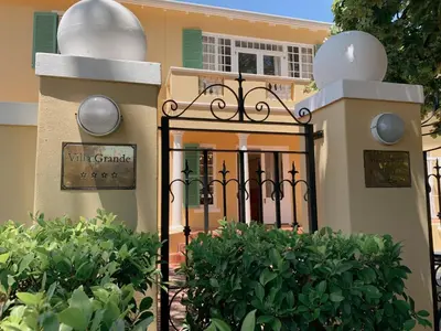 a gate to a house with a sign on it at De Haas Luxury Living at Villa Grande in Stellenbosch