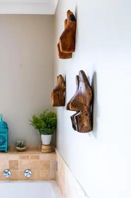 a bathroom with three pieces of art on the wall at The Riverstone House in Romansrivier