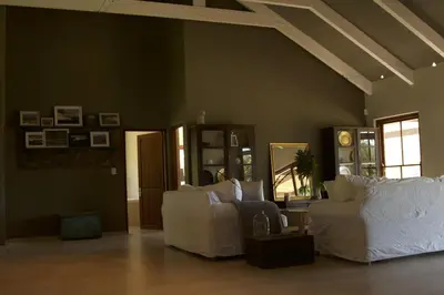 a living room with two white couches in a room at The Riverstone House in Romansrivier