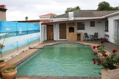 a swimming pool in front of a house at 34 On Marten Crescent in Table View