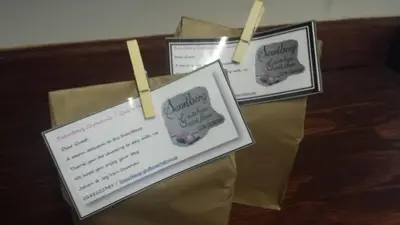 three certificates hanging on a clothes line in a room at Swartberg Guest House in Caledon