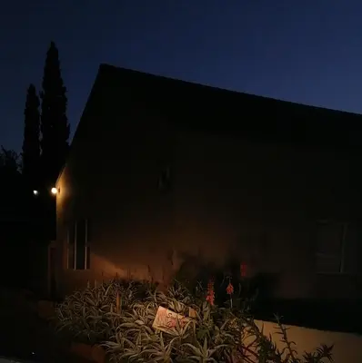 a building with a sign in front of it at night at Swartberg Guest House in Caledon