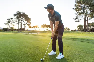 a man is playing golf on a golf course at Pearl Valley Hotel in Franschhoek