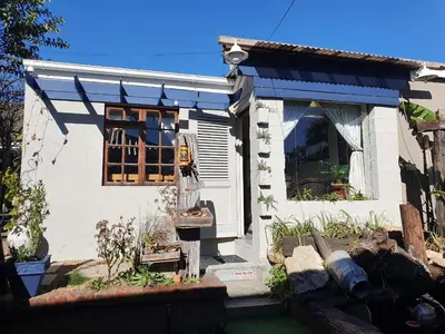 a small white house with a blue awning at Strand Guesthouse in Strand