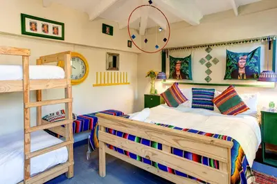 a bedroom with a bunk bed and a ladder at Strand Guesthouse in Strand