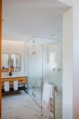 a bathroom with a glass shower and a sink at Laborie Estate in Paarl