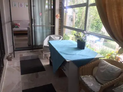 a blue table in a room with a large window at Marshrose Accommodation in Bellville