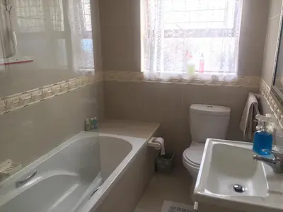a bathroom with a tub and a toilet and a sink at Marshrose Accommodation in Bellville
