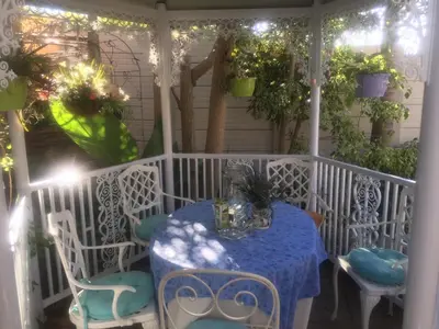 a table and chairs on a porch with plants at Marshrose Accommodation in Bellville