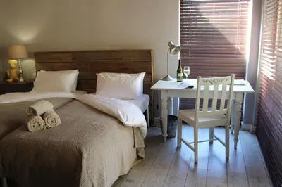 a bedroom with a bed and a table and a chair at 35 on Basil in Caledon
