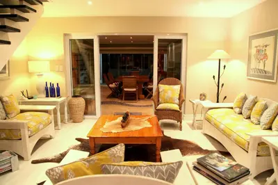 a living room with a couch and a table at Charming Fisante house in Hermanus