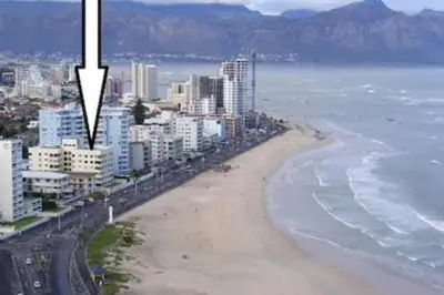 an aerial view of a beach and the ocean at Beach front property in Strand