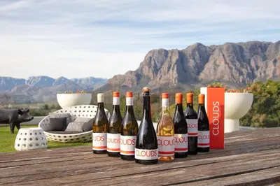 a group of bottles of wine sitting on a table at Clouds Estate in Stellenbosch
