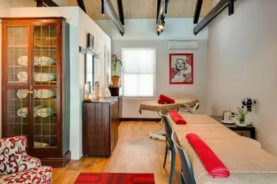 a living room with a table and a dining room at Protea Hotel by Marriott Dorpshuis & Spa Stellenbosch in Stellenbosch