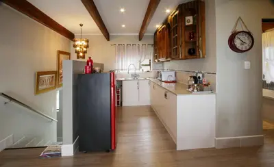 a kitchen with a black and red refrigerator at Eagleview Guesthouse in Hermanus