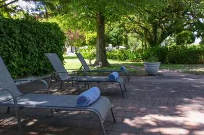 a group of chairs and a table in a park at Andreas Country House in Wellington