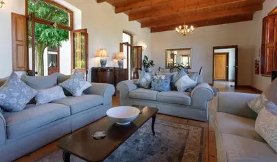 a living room with two couches and a table at Andreas Country House in Wellington