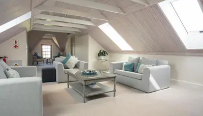 a living room with couches and a table at Andreas Country House in Wellington