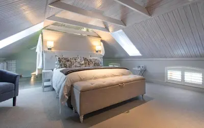 a bedroom with a large bed in a attic at Andreas Country House in Wellington