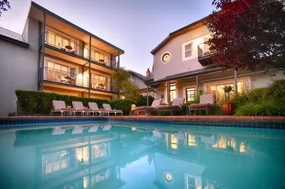 a swimming pool in front of a building at Bonne Esperance Boutique Guest House in Stellenbosch