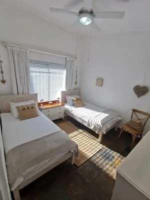 a bedroom with two beds and a window at Brander View in Hermanus