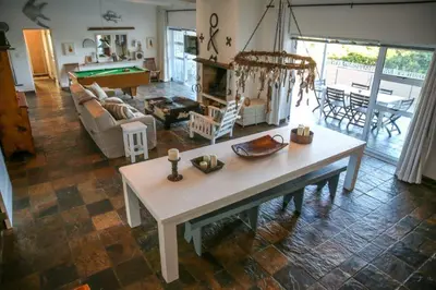 a living room with a table and a pool table at Brander View in Hermanus