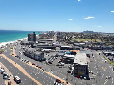an aerial view of a city with a parking lot at Dolphin Inn Blouberg in Bloubergstrand