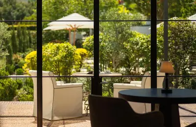 a view of a patio with a table and chairs at Maison Cabrière Boutique Hotel in Franschhoek