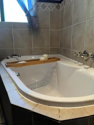 a white bath tub in a bathroom with a window at Panorama Self Catering in Panorama