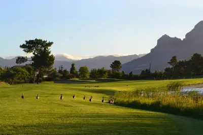 a group of people playing on a golf course at Pearl Valley Suites in Simondium