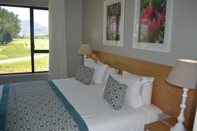 a bedroom with a bed with a large window at Pearl Valley Suites in Simondium