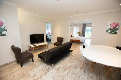 a living room with a couch and a table at Lamabeach city farm in Cape Town