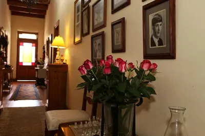 a vase filled with pink roses sitting on a table at Centre-Ville Guest House in Franschhoek