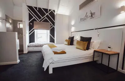 a bedroom with a large white bed and a window at Boschenmeer House in Paarl