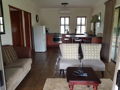 a living room with a couch and a table at Paddabult Self Catering Cottages in Paarl