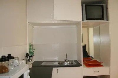 a small kitchen with a sink and a microwave at N-One Self Catering in Goodwood