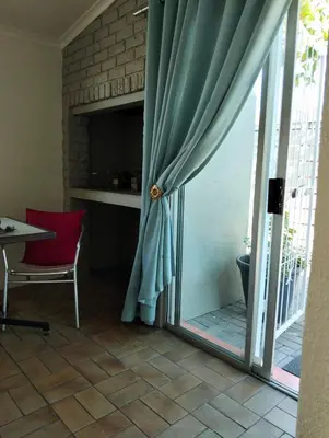 a room with a sliding glass door with a window at N-One Self Catering in Goodwood