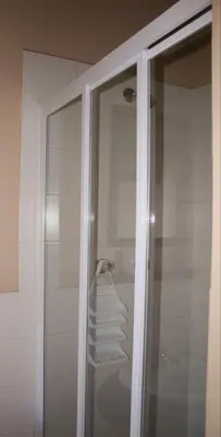 a shower with a glass door in a bathroom at N-One Self Catering in Goodwood