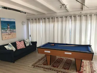 a living room with a pool table and a couch at Akwa in Hermanus