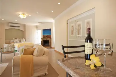 a bottle of wine on a table in a living room at Somerset West Self Catering Vacation Rental - Experience the Best of Cape Town - Wine, Golf, Sea in Somerset West
