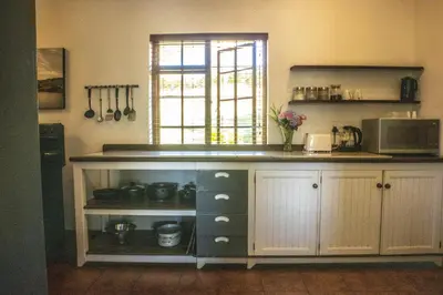 a kitchen with a counter top and a microwave at Zebra Cottage and Lodge in Stellenbosch