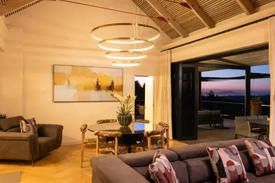 a living room with a couch and a table at Kunjani Villas & Wines in Stellenbosch