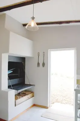 a living room with a tv and a window at Dennehof Farm Guesthouse in Villiersdorp