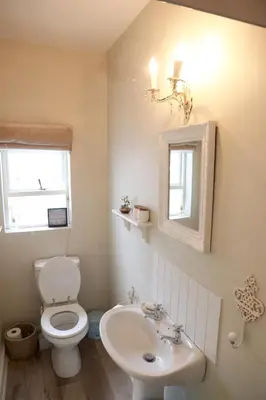 a bathroom with a toilet and a sink at The Birdhouse in Cape Town