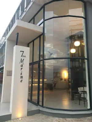 a large glass door of a building with a sign on it at 7 on Marine in Hermanus