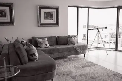 a living room with a couch and a camera at 7 on Marine in Hermanus