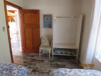 a room with a door and a chair and a room with a bed at Town and Country in Caledon