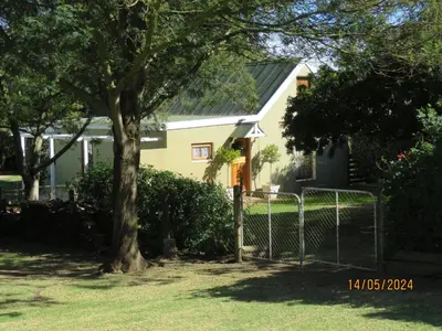 a house with a tree and a fence at Town and Country in Caledon