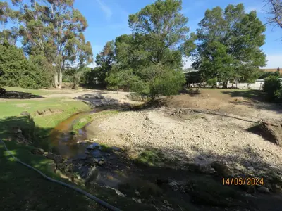 a park with trees and a stream at Town and Country in Caledon